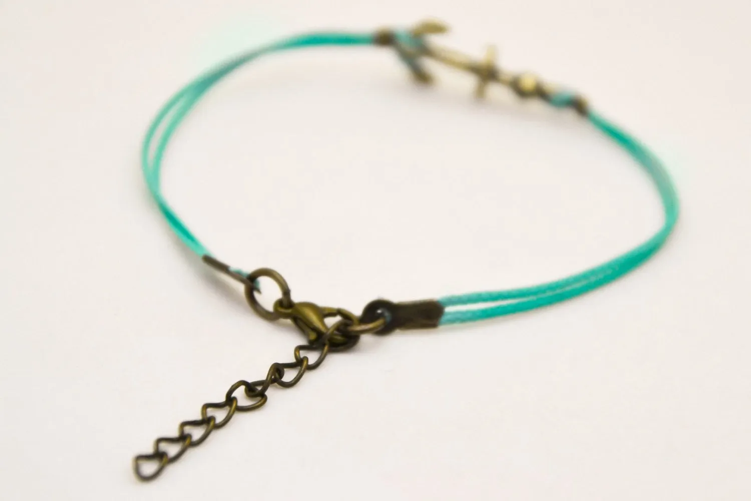 Cord bracelet with a bronze tone anchor charm, turquoise string, gift wrapped handmade